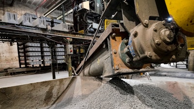 Excess material from freshly made concrete blocks, created with liquid carbon dioxide as an ingredient, is collected for reprocessing at the Glenwood Mason Supply Company, Tuesday, April 18, 2023, in the Brooklyn borough of New York.