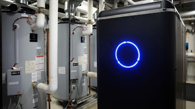 A CarbinX unit, which is about the size of two refrigerators, has been installed and is operating at a Radisson Blu in Bloomington, Minn., on March 21, 2023. The system, which captures carbon dioxide, is eventually used to make soap.