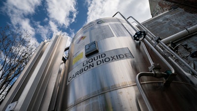 A liquid carbon dioxide containment unit stands outside the fabrication building of Glenwood Mason Supply Company, Tuesday, April 18, 2023, in the Brooklyn borough of New York.