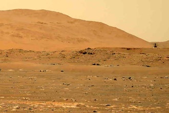 In this April 30, 2021, file image taken by the Mars Perseverance rover and made available by NASA, the Mars Ingenuity helicopter, right, flies over the surface of the planet.