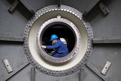 In this photo released by Xinhua News Agency, a worker measures the size of an equipment at Harbin Turbine Company Limited of Harbin Electric Corporation in Harbin in northeastern China's Heilongjiang Province on Friday, April 28, 2023.