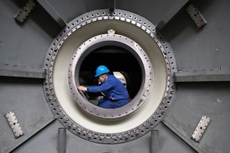 In this photo released by Xinhua News Agency, a worker measures the size of an equipment at Harbin Turbine Company Limited of Harbin Electric Corporation in Harbin in northeastern China's Heilongjiang Province on Friday, April 28, 2023.