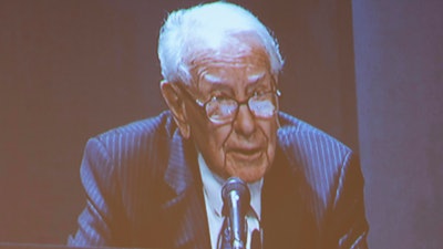 Shareholders watch Warren Buffett from the overflow room during the Berkshire Hathaway annual meeting on Saturday, May 6, 2023, in Omaha, Neb.