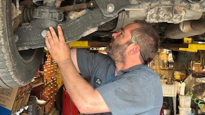 Mechanic Jon Guthrie inspects the underside of a 2014 Honda Ridgeline pickup truck at Japanese Auto Professional Service in Ann Arbor, Michigan.