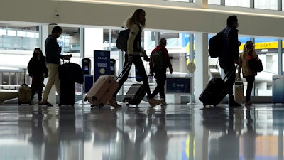 Travelers walk through a domestic terminal at San Francisco International Airport in San Francisco, Friday, May 26, 2023. On Wednesday, the Conference Board reports on U.S. consumer confidence for May.