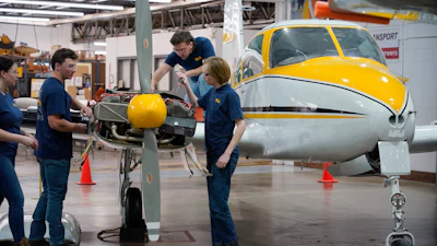 Students at the Pittsburgh Institute of Aeronautics from left: Nikki Reed, William Onderdonk, Jeffrey Natter and Joshua Lindberg study an engine on a Cessna 310 aircraft in West Mifflin, Pa., Tuesday, May 2, 2023.