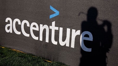 The Accenture logo is displayed on a scrim as Denmark's Thomas Bjorn's shadow is cast onto it while he practices for the Match Play Championship, Feb. 20, 2012, in Marana, Ariz.