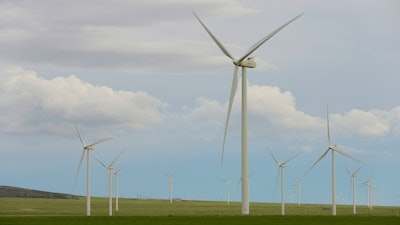 Wind turbines stand at a wind farm along the Montana-Wyoming state line on June 13, 2022.