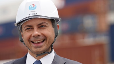 U.S. Secretary of Transportation Pete Buttigieg reacts as he was walking around the Yokohama Port during a tour which includes a visit to a construction site for a new pier that will accommodate larger ships coming from the U.S. on Monday, June 19, 2023, in Tokyo.