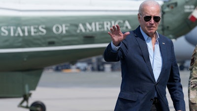President Joe Biden waves as he walks to board Air Force One at Dover Air Force Base, Del., Monday, June 19, 2023, as he heads to California.