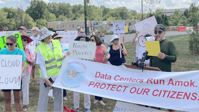 Dale Browne, president of the Great Oak Homeowners Association, speaks Aug. 29, 2022, at a rally near Manassas, Va., protesting a newly built data center for Amazon Web Services.