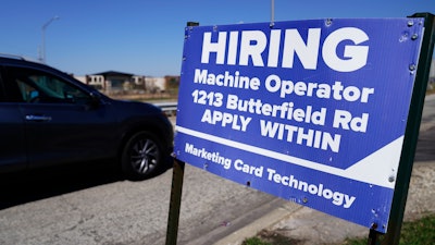 A hiring sign is seen in Downers Grove, Ill., Wednesday, April 12, 2023.