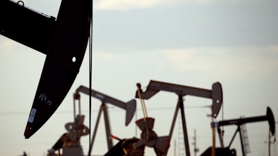 Pump jacks work in a field near Lovington, N.M., April 24, 2015. New Mexico oilfield and air quality regulators on Thursday, June 29, 2023, announced unprecedented state fines against a Texas-based oil and natural gas producer on accusations that the company flouted local pollution reporting and control requirements by burning off vast amounts of natural gas in a prolific energy-production zone in the southeast of the state.