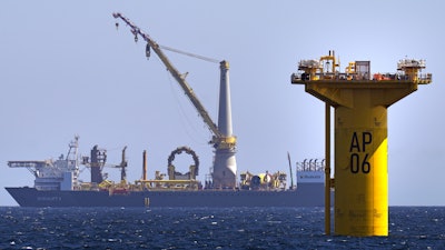 A monopile, at right, awaits the addition of its wind tower, hub and nacelle at the South Fork Wind project, Tuesday, July 11, 2023, off the coast of Rhode Island.