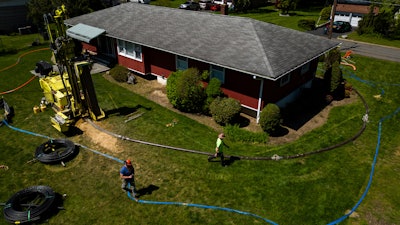 A drill rig for a geothermal heat pump sits outside a home in White Plains, N.Y., Monday, May 8, 2023.