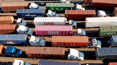 Trucks line up to enter a Port of Oakland shipping terminal on Nov. 10, 2021, in Oakland, Calif.