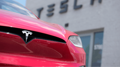 An unsold 2023 Model X sports-utility vehicle sits outside a Tesla dealership Sunday, June 18, 2023, in Littleton, Colo.