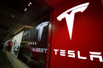 A sign bearing the Tesla company logo is displayed outside a Tesla store in Cherry Creek Mall in Denver, Feb. 9, 2019.