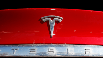The Tesla company logo is shown at a Tesla dealership in Littleton, Colo., Feb. 2, 2020.