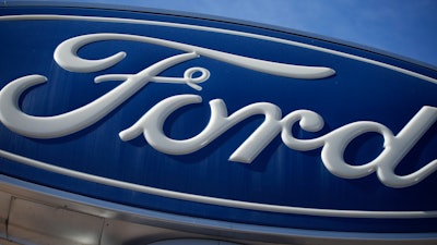 This Oct. 24, 2021 file photo shows a Ford company logo on a sign at a Ford dealership in southeast Denver.