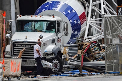 Part of the extension arm from a hi-rise construction crane lies crashed against a cement truck, Thursday July 27, 2023, in New York.