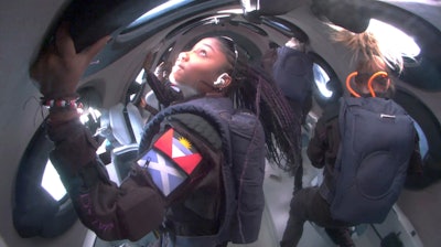 This photo provided Virgin Galactic shows passengers during Virgin Galactic's first space tourism flight on Thursday Aug. 10, 2023.