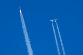 Virgin Galactic's rocket-powered plane Unity 22, left, flies past its mothership Eve on its way to the edge of space after taking off from Spaceport America, near Truth or Consequences, N.M., Thursday, Aug. 10, 2023.