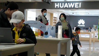 People visit a Huawei franchise store in Beijing on April 28, 2023. Chinese tech giant Huawei on Friday, Aug. 11, reported its revenue rose 3% over a year earlier in the first half of 2023 and its profit margin widened despite sanctions that block access to U.S. processor chips and other technology.