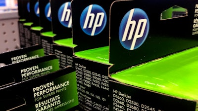 This Aug. 15, 2019, photo shows the HP logo on Hewlett-Packard printer ink cartridges at a store in Manchester, N.H.