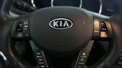 The Kia logo brands a steering wheel inside of a Kia car dealership in Elmhurst, Ill., Oct. 5, 2012.