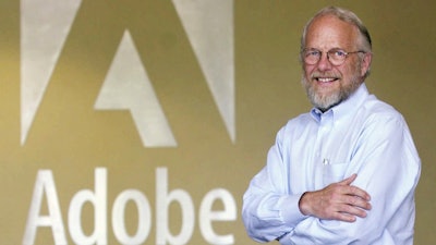 Adobe co-founder John Warnock smiles in the lobby at Adobe headquarters in San Jose, Calif., on May 9, 2001.