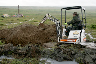 A worker with the Pebble Mine project digs in the Bristol Bay region of Alaska near the village of Iliamma, Alaska, July 13, 2007.