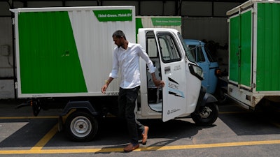 An electric rickshaw delivery driver exits after parking the vehicle at logistics company City Link in Bengaluru, India, Wednesday, May 31, 2023.