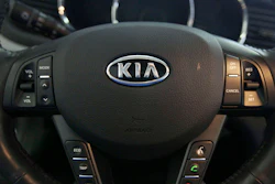 The Kia logo brands a steering wheel inside of a Kia car dealership in Elmhurst, Ill., Oct. 5, 2012.