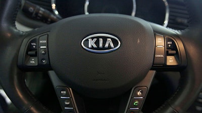 The Kia logo brands a steering wheel inside of a Kia car dealership in Elmhurst, Ill., Oct. 5, 2012.