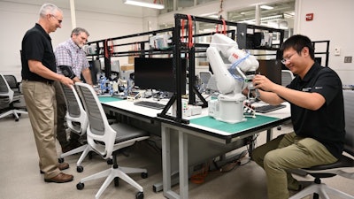 From left, Jim Noble, Mike Klote and Yi Wang from the University of Missouri College of Engineering examine equipment in one of the college's two existing manufacturing core labs.