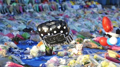 Tributes are placed outside Leicester City Football Club, Leicester, England, Oct. 29, 2018, after a helicopter crashed in flames Saturday.