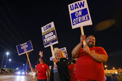 Picketers stand next to a road outside the Stellantis Toledo Assembly Complex early Friday, Sept. 15, 2023, in Toledo, Ohio.