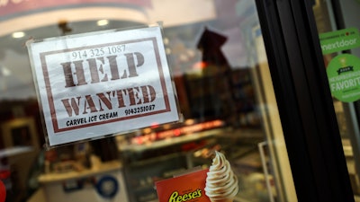 A help-wanted sign posted in a storefront in Bedford, N.Y., Nov. 1, 2022.