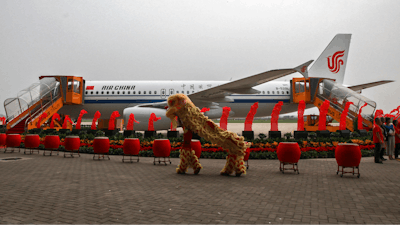 Dancers perform a lion dance near the 100th A320 airplane assembled at the Tianjin plant of Airbus in north China's Tianjin Municipality on Aug. 31, 2012.