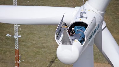 A technician makes adjustments to a wind turbine in Colorado.