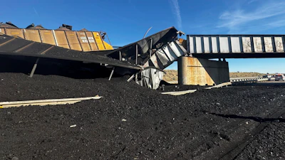In this photo released by the Pueblo County Sheriff's Office, the wreckage of a train derailment is pictured near Pueblo, Colo., Sunday, Oct. 15, 2023. The train derailment Sunday spewed coal and mangled train cars across the highway.