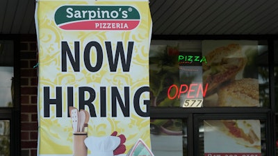 A hiring sign is displayed at a restaurant in Palatine, Ill., Wednesday, Sept. 13, 2023.