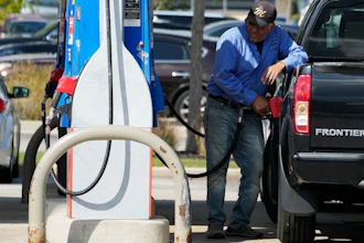 A man fuels his truck at a gas station in Palatine, Ill., Wednesday, Sept. 13, 2023. Higher longer-term interest rates coincide with other threats to economic growth, from higher gas prices and the resumption of student loan payments to the autoworkers’ strike and the risk of a government shutdown next month.