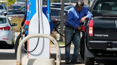 A man fuels his truck at a gas station in Palatine, Ill., Wednesday, Sept. 13, 2023. Higher longer-term interest rates coincide with other threats to economic growth, from higher gas prices and the resumption of student loan payments to the autoworkers’ strike and the risk of a government shutdown next month.