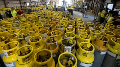 Used refrigerant cylinders sit in a warehouse at the A-Gas Rhome facility on Monday, Oct. 9, 2023, in Rhome, Texas. The company takes in shipments of refrigerators and tanks from around the country and beyond, drains them, then purifies and reclaims the chemicals, shipping out recycled product. This prevents the need for new chemical production.