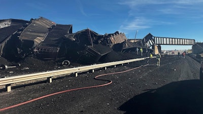 In this photo released by the Pueblo County Sheriff's Office, police respond to the scene of a train derailment near Pueblo, Colo., Sunday, Oct. 15, 2023.