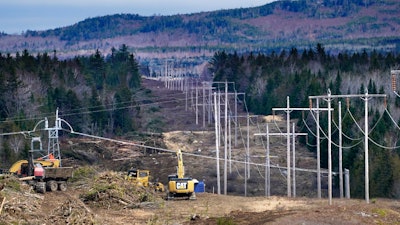 Heavy machinery is used to cut trees to widen an existing Central Maine Power power line corridor to make way for new utility poles, April 26, 2021, near Bingham, Maine.