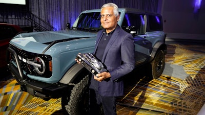 Kumar Galhotra, Ford President of the Americas and International markets group poses next to the Bronco off-road SUV, Tuesday, Jan. 11 2022 in Detroit.