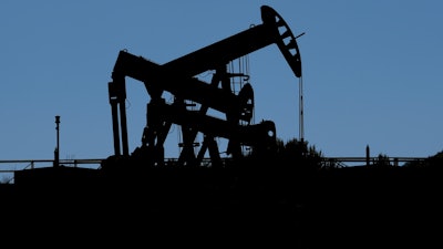 Pumpjacks dip their heads to extract oil in a basin south of Duchesne, Utah on July 13, 2023.